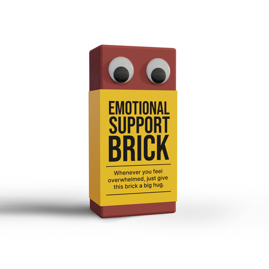 “Emotional Support Brick” novelty gag gift featuring brown brick with googly eyes and humorous yellow label from SendNonsense