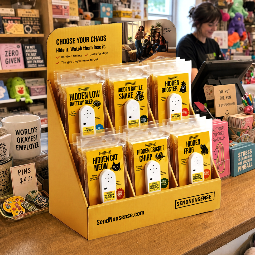 A yellow retail display stand filled with packaged novelty 'Hidden' snack packs in a shop setting. The packages include Hidden Low Battery Beef, Hidden Battle Snake, Hidden Roaster, Hidden Cat Meow, Hidden Cricket Chirp, and Hidden Frog, with the brand SendNonsense visible on the packaging and display.