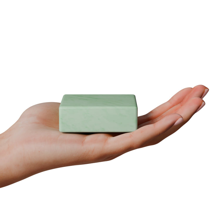 Hand holding a Adulting is Hard gag gift soap in mint green