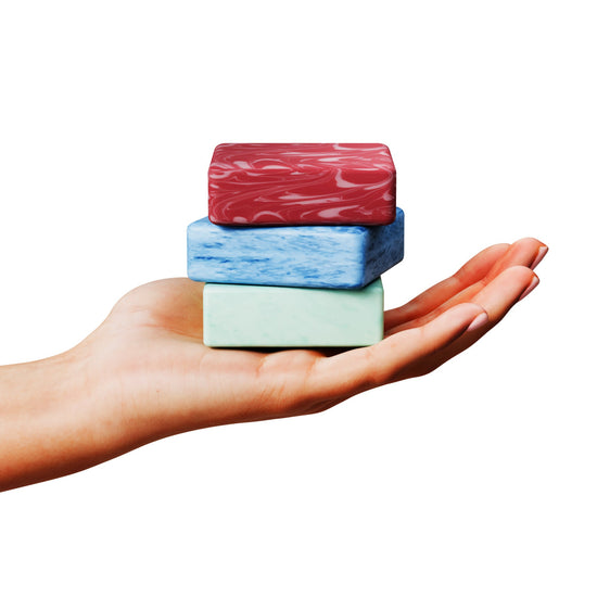 Hot Mess Survival Soaps” gag gift showing three novelty soap bars stacked in a hand, coral, beige and mint green with handmade look