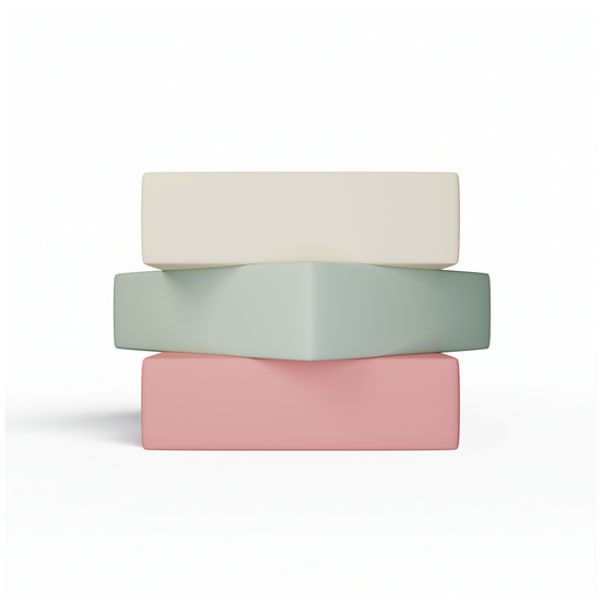 Three stacked cylindrical containers in beige, green, and pink on a white background