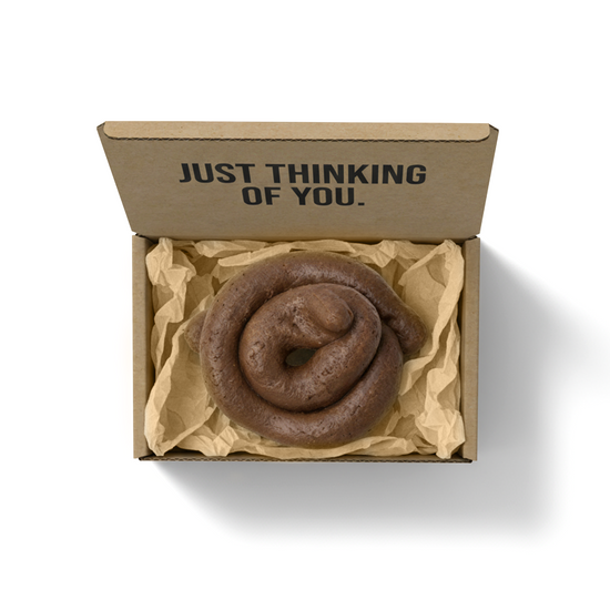 “Mystery Turd” prank gag gift box with fake poop and humorous message “Just Thinking of You” printed on inside packaging